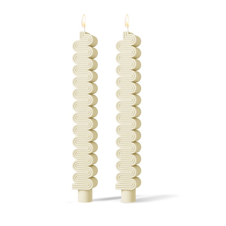 two white candles sitting next to each other