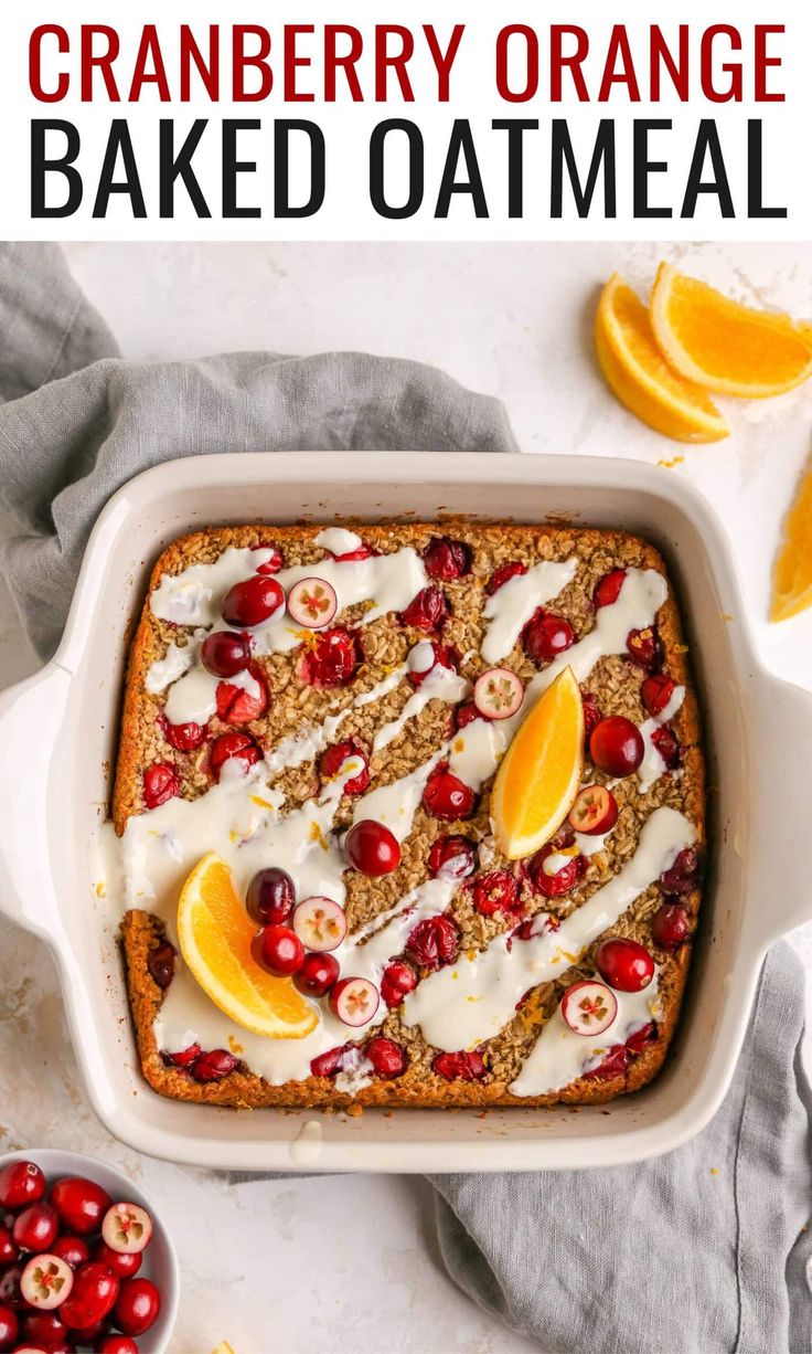 cranberry orange baked oatmeal in a casserole dish with fresh fruit on the side