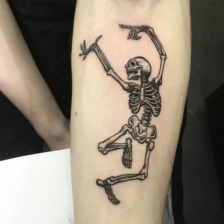 a skeleton tattoo on the right thigh with an arrow in it's left arm