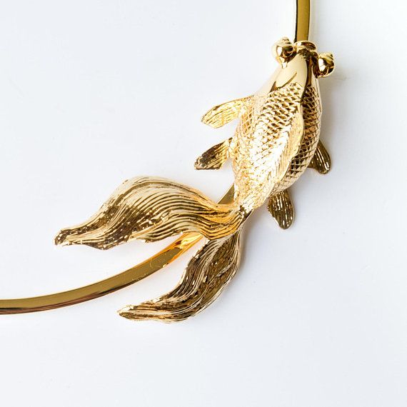 the gold fish is hanging from the hook