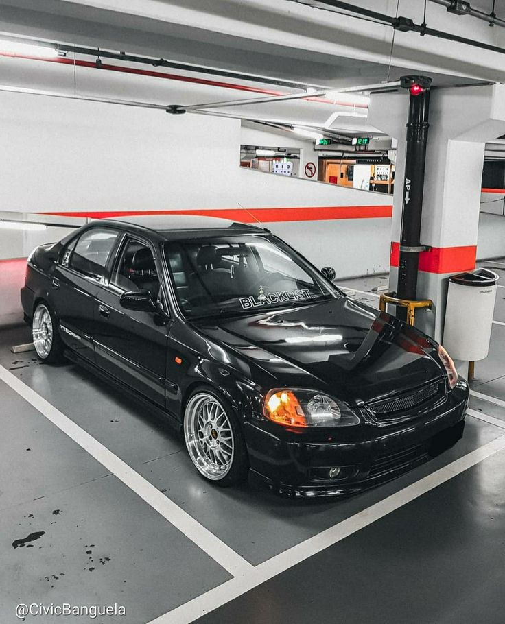 a black car parked in a parking garage