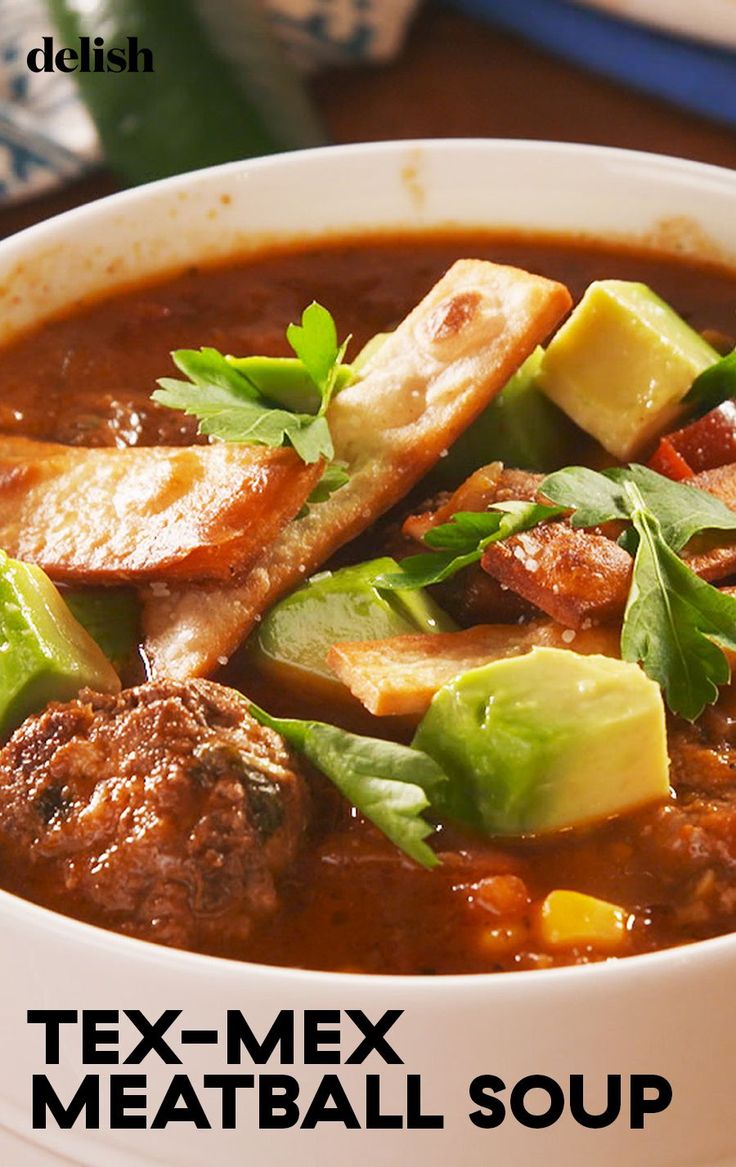 a bowl of tex - mex meatball soup on a table