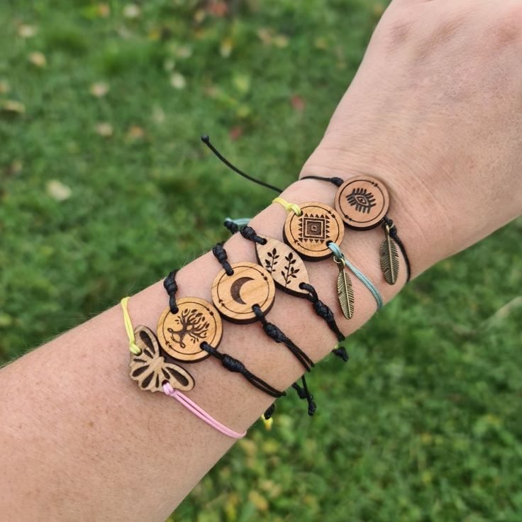 a person's arm with bracelets made out of wooden discs and beads on it