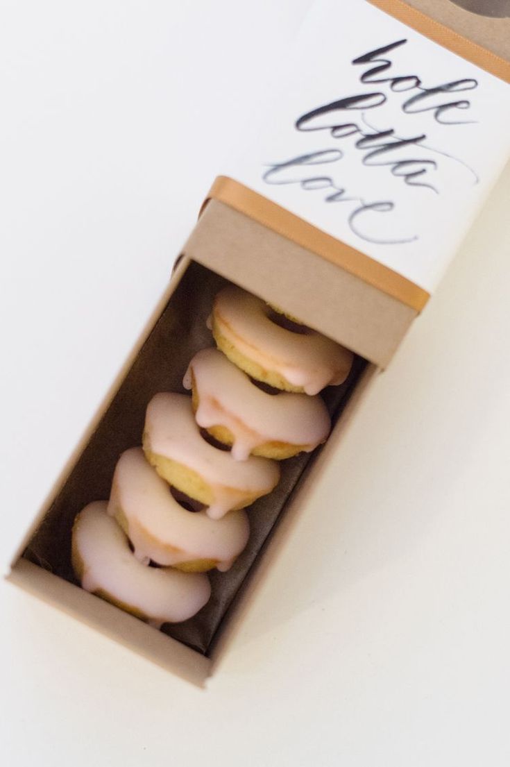 a box filled with donuts sitting on top of a table