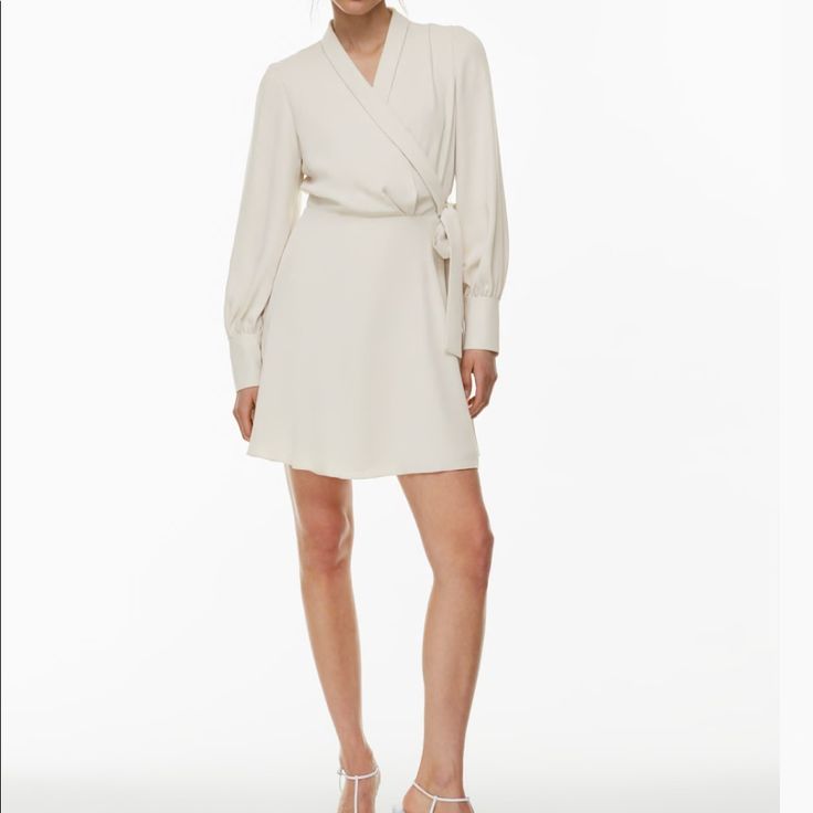 Brand New/Never Worn Aritzia Babaton Hyde Mini Dress Color: Matte Pearl Size: Medium (Tts) Passed The Return Date & No Longer Needed This Is A Collared Mini Wrap Dress With Button-Closure Cuffs And A Waist Tie. It’s Made With Studio Drape Drapey Matte Satin With A Smooth Look And Lightweight Feel. Elegant A-line Wrap Dress For Date Night, Elegant Viscose Mini Dress For Daywear, Spring Long Sleeve Viscose Wrap Dress, Elegant Long Sleeve Mini Dress For Daywear, Chic Viscose Mini Dress For Daywear, Elegant Long Sleeve Viscose Wrap Dress, Cream Mini Length Work Dresses, Neutral Long Sleeve Dresses For Work, Elegant Summer Mini Dress In Viscose