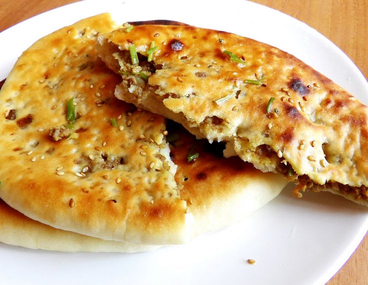 two pieces of bread on a plate with the words keema naman written below it