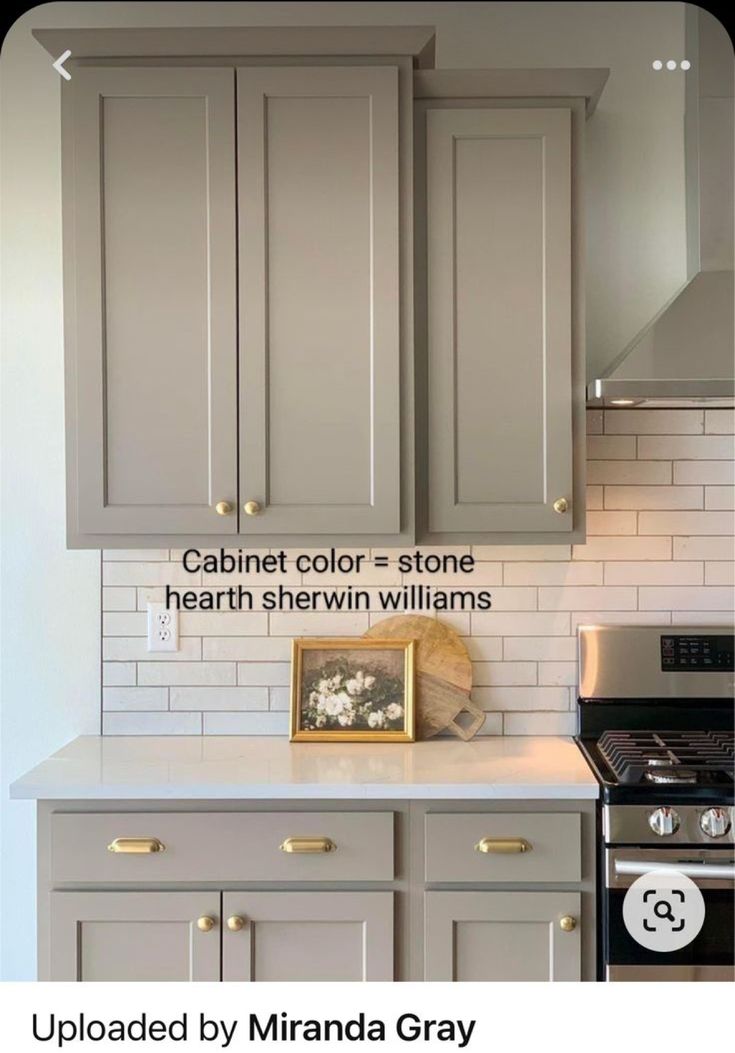 a kitchen with gray cabinets and white subway backsplash, painted by miranda gray