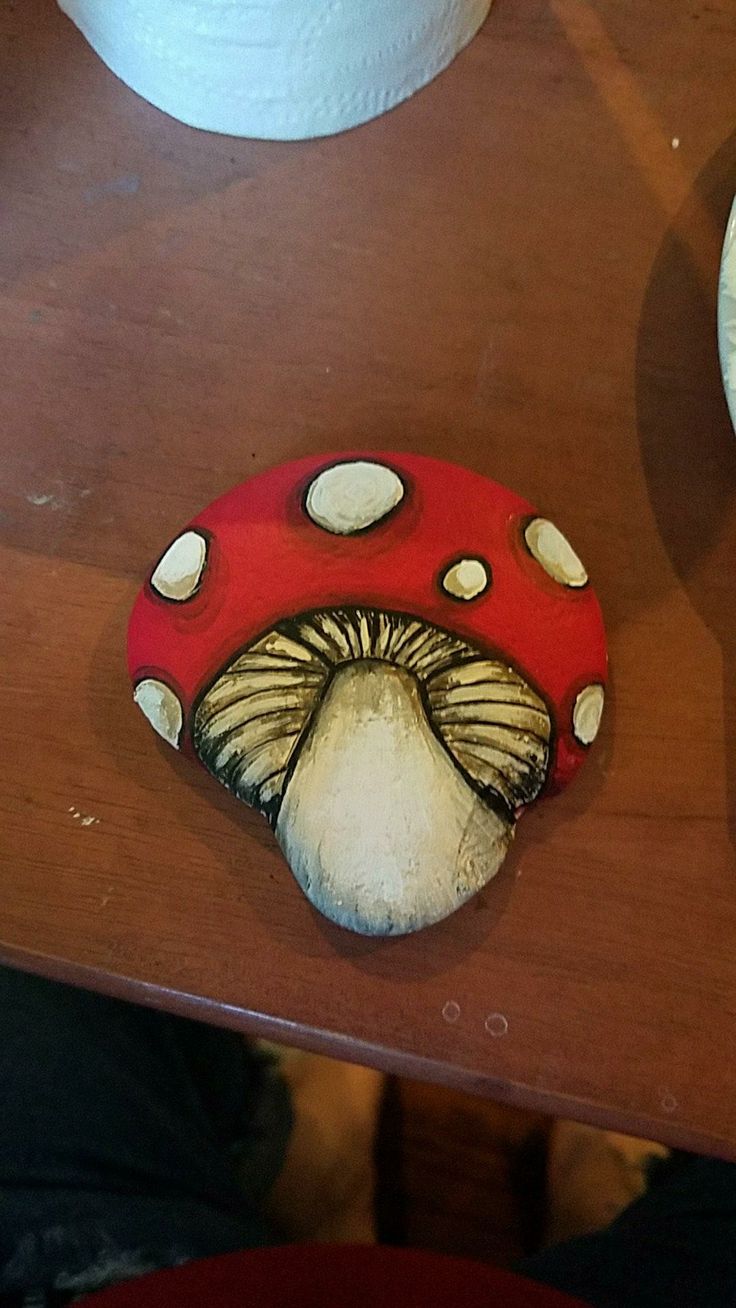 a red mushroom sitting on top of a wooden table