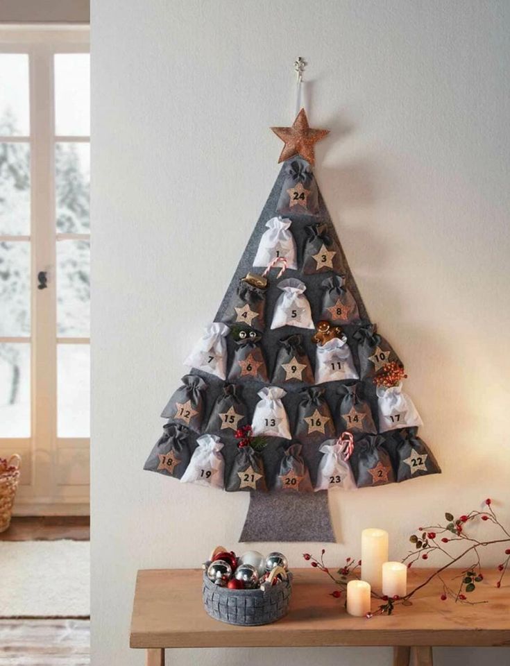 a christmas tree made out of photos is shown in two different angles, with candles on the table