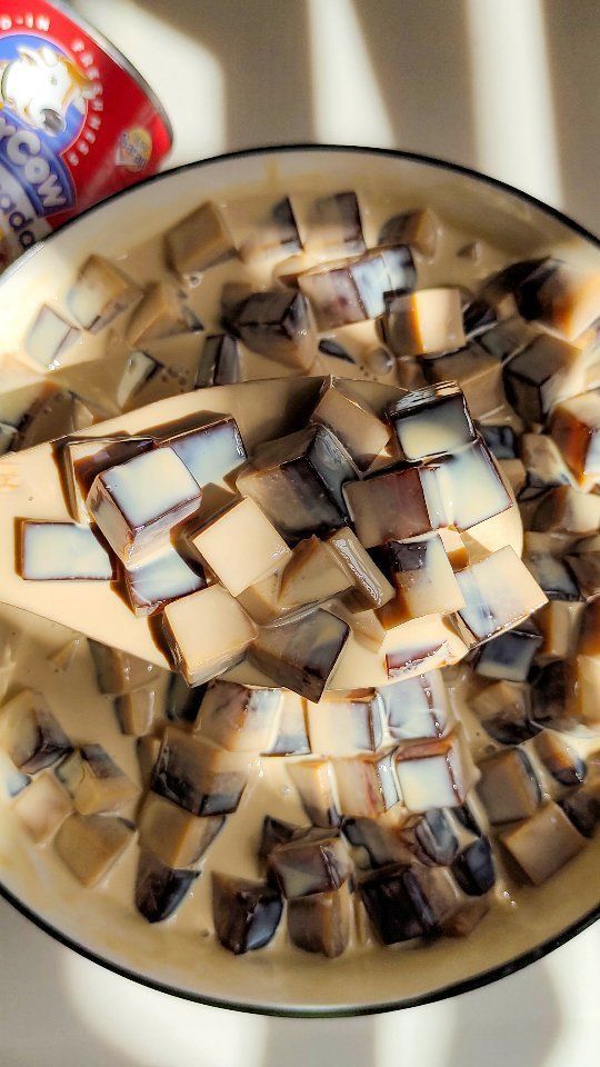 a cup filled with liquid and ice cubes