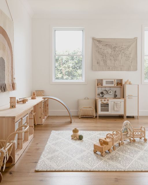 a child's play room with toys and rugs on the hardwood flooring