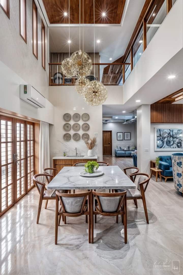 the dining room table is surrounded by wooden chairs and chandelier hanging from the ceiling