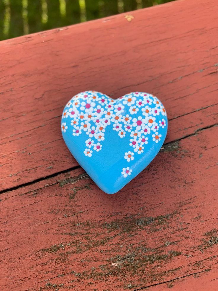 a blue heart shaped object sitting on top of a wooden table