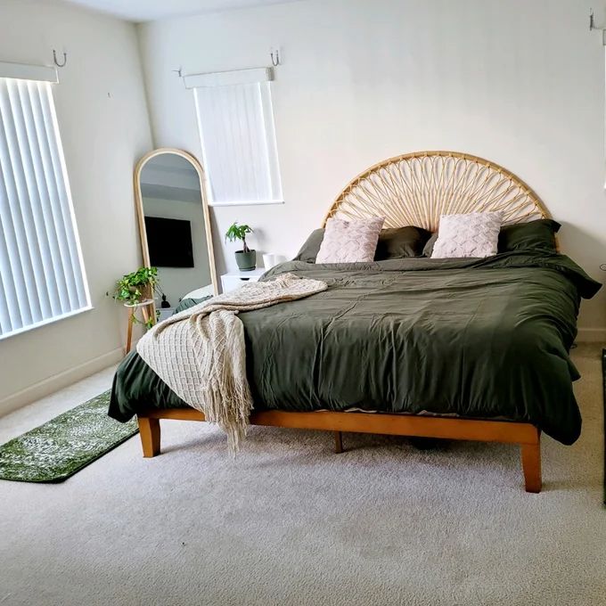 a bedroom with a bed, dresser and mirror in it's centerpieces