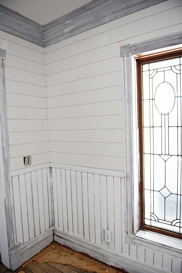 an empty room with stained glass windows and wood flooring on the ground below it