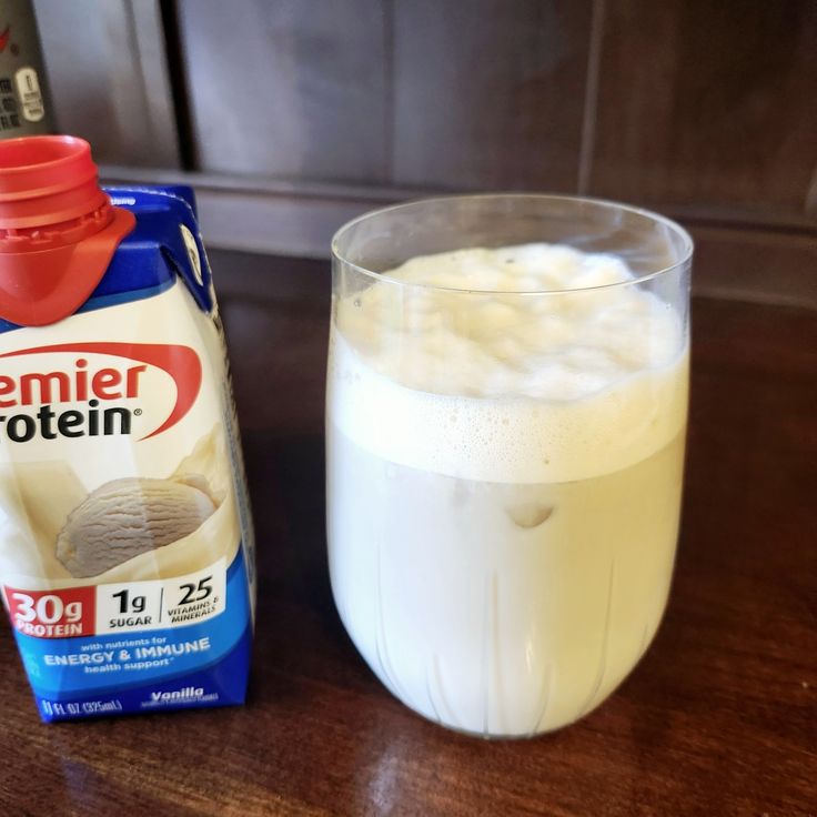 a glass of milk next to a carton of yogurt