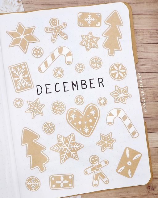 an open notebook with stickers on it and the words december written in black ink