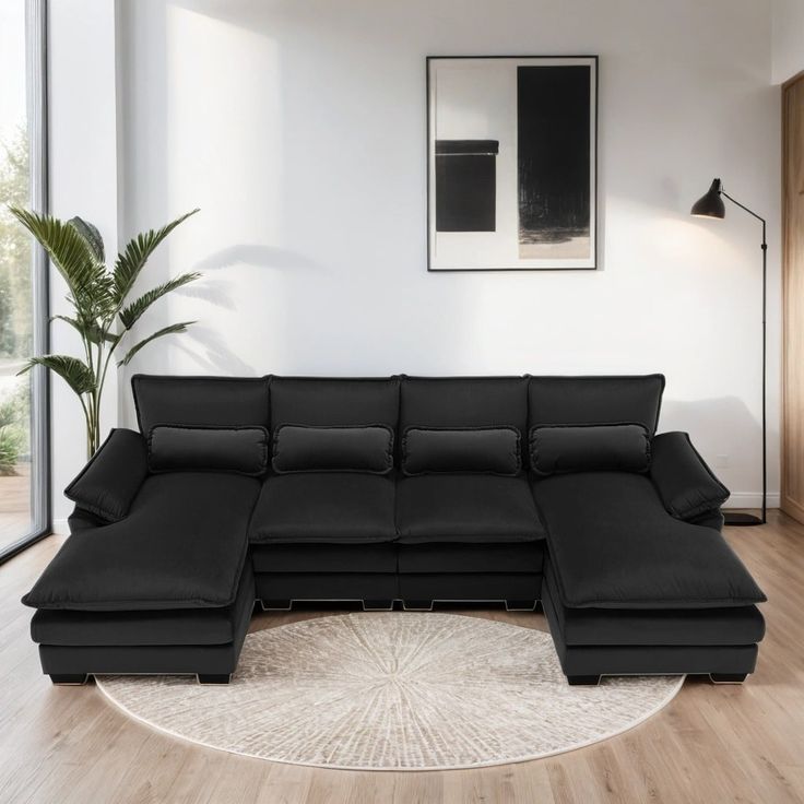 a living room with a large black sectional couch