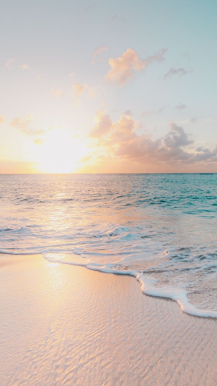 the sun is setting over the ocean with waves coming in to shore and green frame