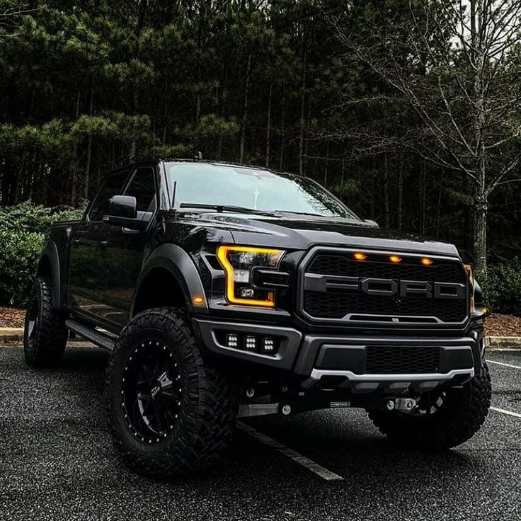 a large black truck parked in a parking lot