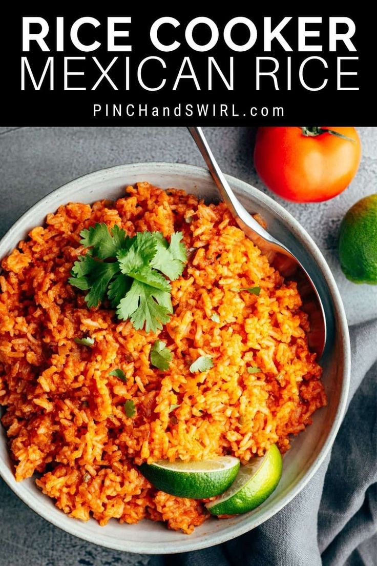 rice cooker mexican rice in a white bowl with limes and tomatoes on the side