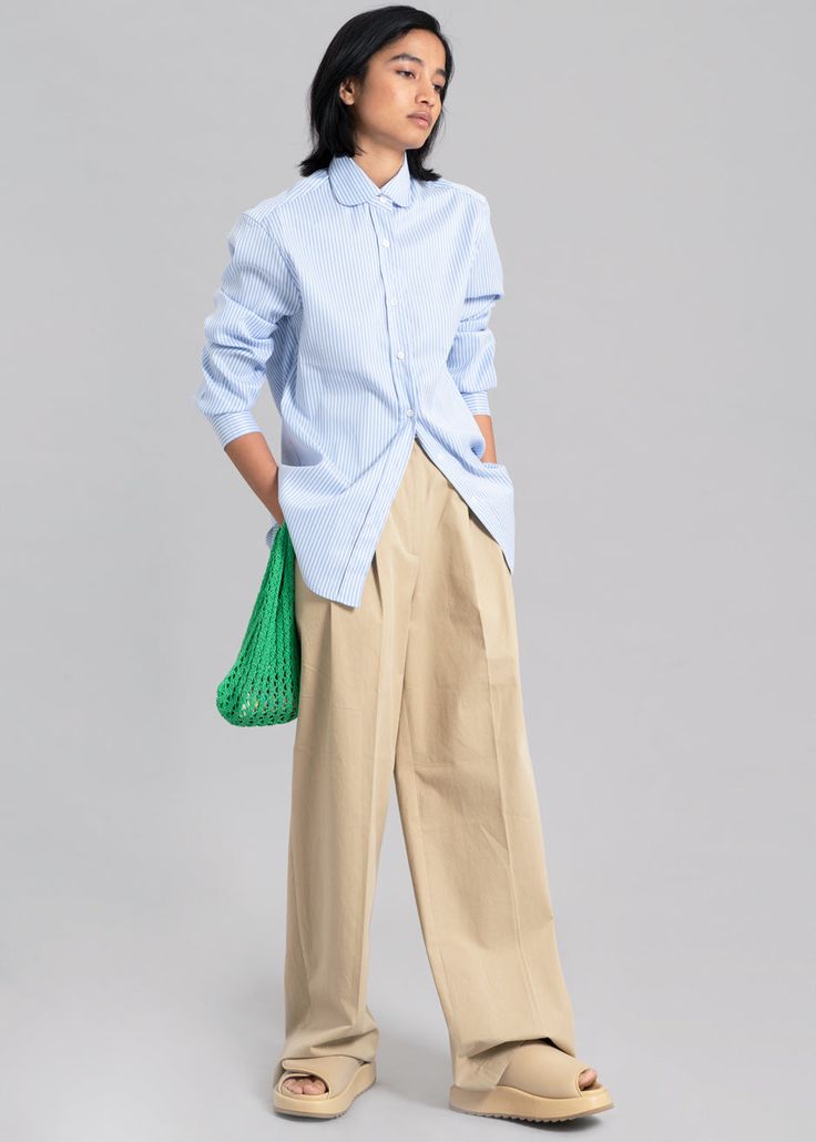 Color: Blue Stripe Woven shirting fabric Regular fit Rounded collar Curved hem Button cuffs Button front closure 96% Polyester 4% PU Dry Clean By The Frankie Shop. Imported Product Measurements: S- 17" Shoulder, 40" Bust, 27.5" Length M- 17.5" Shoulder, 42" Bust, 28" Length L- 18" Shoulder, 44" Bust, 28.5" Length XL- 18.5" Shoulder, 46" Bust, 29" Length Model is 174cm/ 5'8" wearing size S Blue Shirt With Placket And Shirttail Hem, Blue Shirt With Concealed Placket And Fold Down Collar, Blue Relaxed Fit Dress Shirt For Work, Spring Workwear Dress Shirt With Concealed Placket, Spring Dress Shirt With Button Cuffs For Daywear, Light Blue Button-up Blouse For Work, Blue Spread Collar Blouse For Daywear, Light Blue Button Cuffs Shirt For Work, Classic Blue Blouse With Shirttail Hem