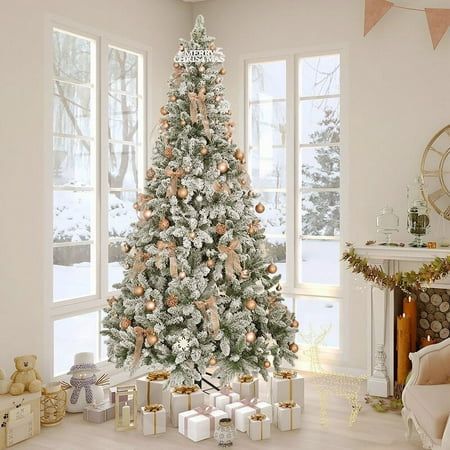 a decorated christmas tree in a living room with presents on the floor next to it