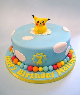 a blue birthday cake with a pikachu on top