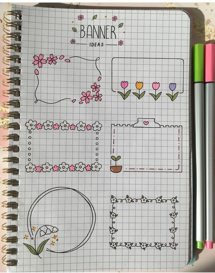 a notebook with flowers and plants drawn on the pages next to two markers that read banner