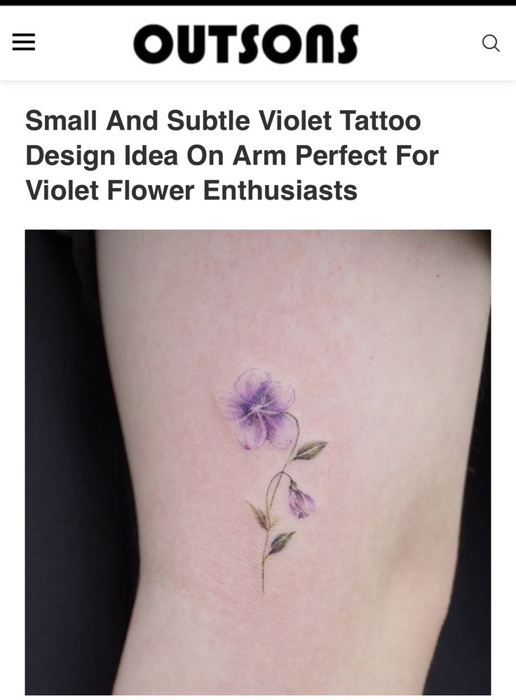 small purple flower tattoo on the side of the thigh, with text below it that reads'small and subtle violet tattoo design idea on arm perfect for violet flower enthusiasts