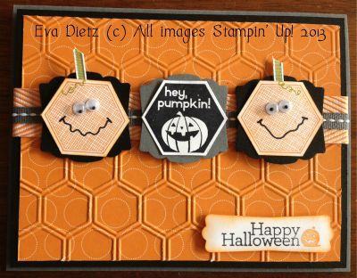 an orange card with three pumpkins on it and the words happy halloween written in black