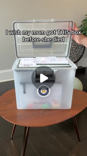 a woman is holding up a cooler with the lid open and it's sitting on top of a table