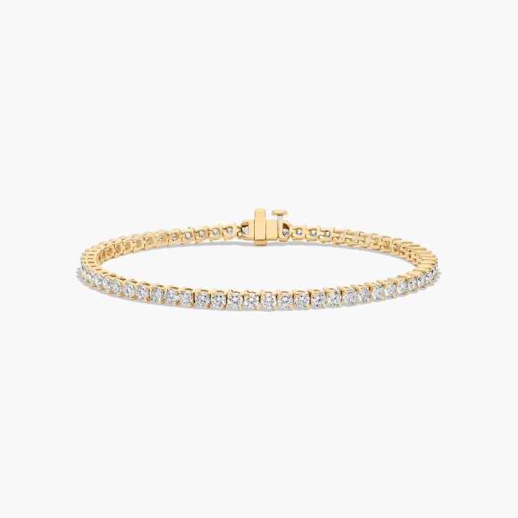 a diamond tennis bracelet in yellow gold