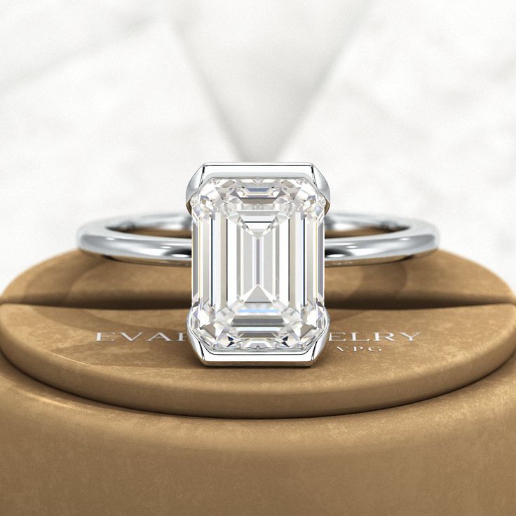 Introducing our stunning 2.50 Carat Emerald Cut Half Bezel Engagement Ring! Crafted with love, this exquisite ring features an emerald cut lab grown diamond set in 14K or 18K yellow gold. Its minimalist design exudes elegance, making it a perfect choice for your proposal. Trust us, this ring will leave her breathless!𝐅𝐞𝐚𝐭𝐮𝐫𝐞𝐬:• 𝐌𝐚𝐝𝐞 𝐭𝐨 𝐎𝐫𝐝𝐞𝐫• 𝐌𝐞𝐭𝐚𝐥: 𝟏𝟒𝐊 𝐆𝐨𝐥𝐝 | 𝟏𝟖𝐊 𝐆𝐨𝐥𝐝 | 𝟗𝟓𝟎 𝐏𝐥𝐚𝐭𝐢𝐧𝐮𝐦 • 𝐁𝐚𝐧𝐝 𝐂𝐨𝐥𝐨𝐫𝐬: Rose Gold, Yellow Gold & White Gold• 𝐁 Classic Emerald Cut Emerald Ring In Rose Gold, Emerald Cut Lab Grown Diamond Ring For Anniversary, Emerald Cut Lab Grown Diamond Anniversary Ring, Timeless Emerald Cut Lab Grown Diamond Ring, Emerald Cut Lab-grown Diamond Ring For Anniversary, Refined Emerald Cut Jewelry As Gift, Refined Emerald Cut Jewelry For Gift, Luxury Solitaire Emerald Cut Diamond Ring, Elegant Emerald Cut Diamond Ring In Sterling Silver