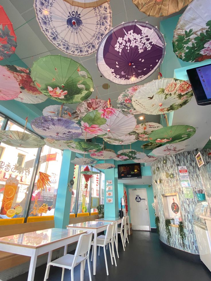 the ceiling is decorated with umbrellas and flowers