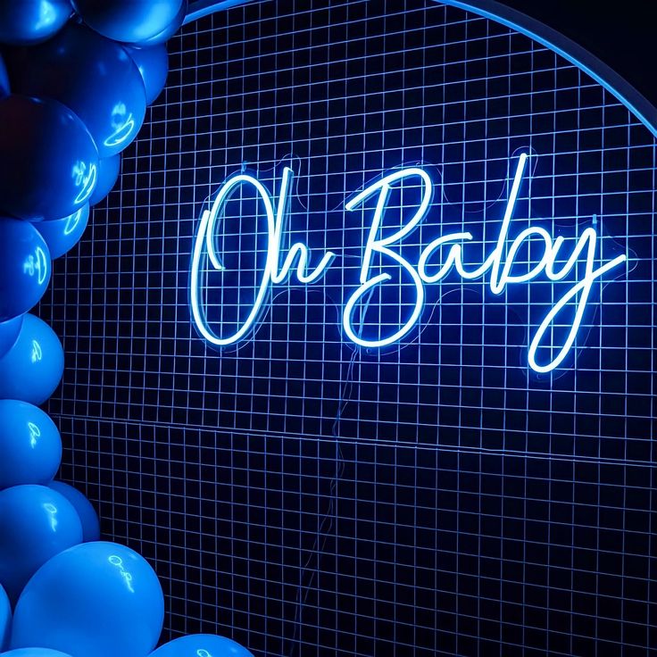 a neon sign that says oh baby with balloons around it and the word on it