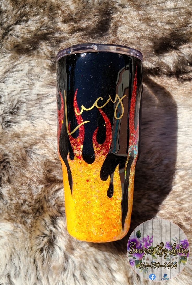 a yellow and black coffee cup sitting on top of a fur covered floor