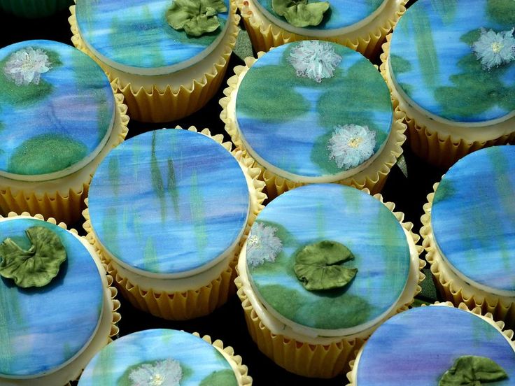 cupcakes decorated with blue and green frosting are arranged in rows on top of each other