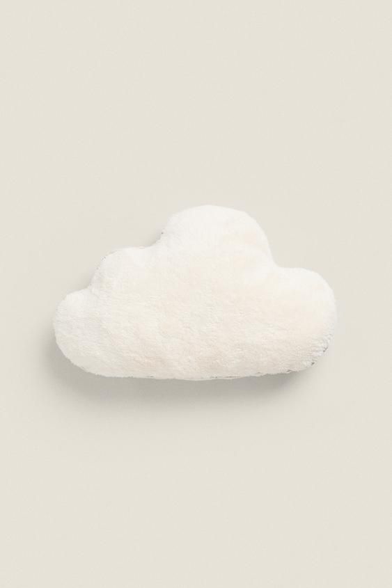 a white cloud shaped object sitting on top of a table