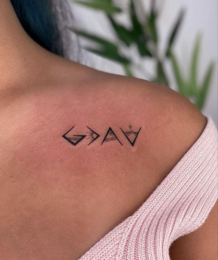 a woman's shoulder with an arrow and crown tattoo on her left shoulder, next to a potted plant