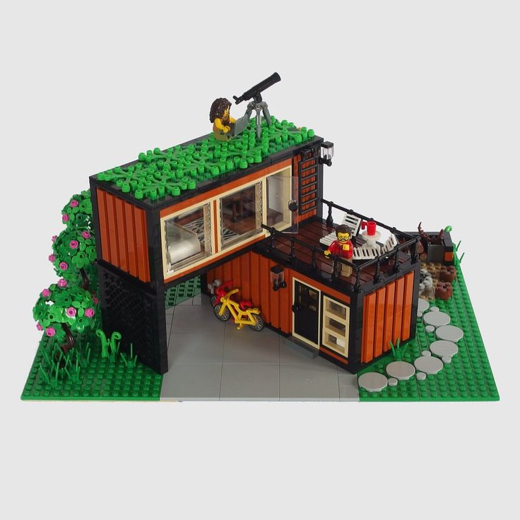 a lego model of a small house made out of legos and other things on display