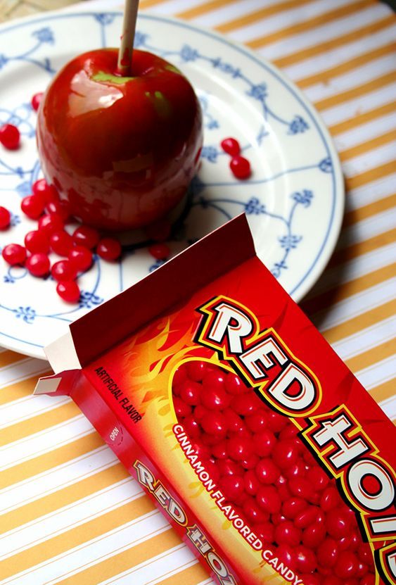 a candy bar sitting on top of a plate next to an apple