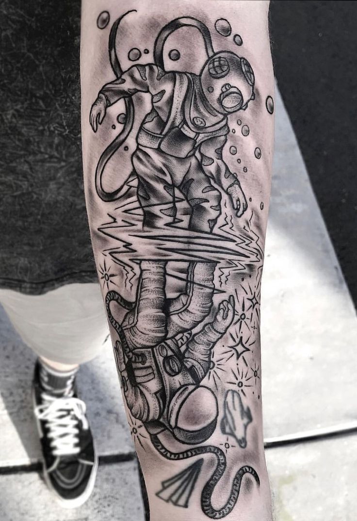 a person with a tattoo on their arm and leg is holding an object in the air