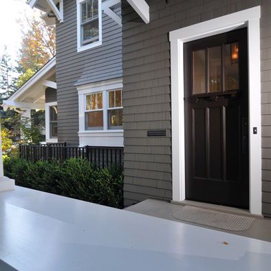 the front door of a house with a lantern hanging over it