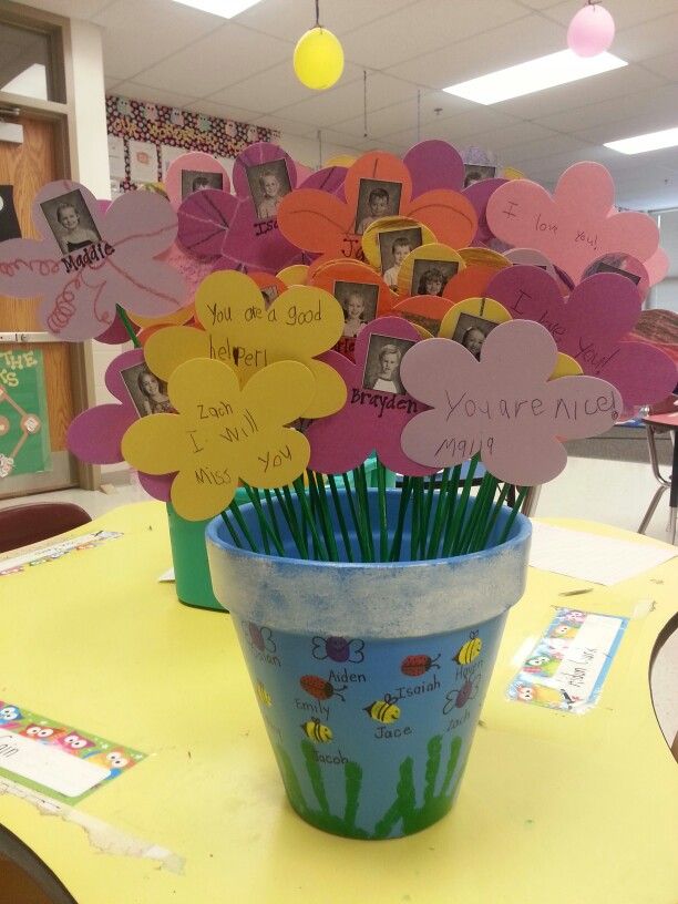 a flower pot filled with paper hearts on top of a table