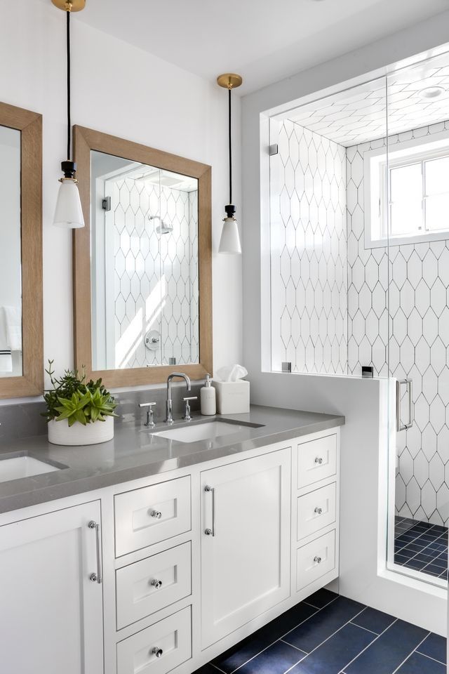 a bathroom with white cabinets and gray counter tops is featured in the instagram ad