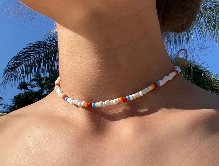 Necklace is approximately 13 inches long with 2 extra inches of chain so it is adjustable  (White/colorful) This is a cute and fun beaded choker necklace with a silver clasp. It has pops of color so it can go with so many different styles and brighten up your day and jewelry collection! (Clear/peach/gold) these lovely chokers are elegant and fun they go with everything! They are made with clear small beads with a slight holographic shine to them and both styles have white and either Pearl/peach or shiny/gold seed beads! Cute Choker Necklaces, White Choker Necklace, Teal Bracelet, Colorful Choker, White Choker, Gold Star Earrings, Colorful Necklace, Necklace Colorful, Dainty Choker