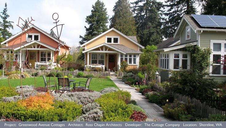 the houses are all different colors and have lawn chairs in front of them with flowers around them