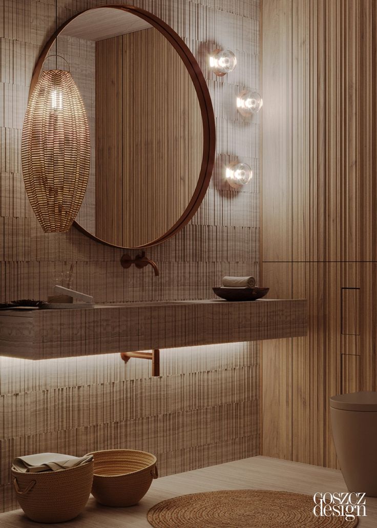 a round mirror on the wall above a sink in a room with wood paneling