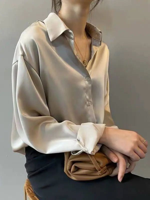 Elegant Silk White Blouse - Classic Long Sleeve Shirt for Women Discover timeless elegance with this luxurious silk white blouse. Featuring a classic design with a relaxed fit, this long sleeve shirt is perfect for both professional and casual settings. The soft, silky fabric drapes beautifully, offering comfort and style in one. Pair it with tailored trousers for a sophisticated office look or with jeans for a chic, effortless outfit. Versatile and stylish, this blouse is a must-have addition t Cream Satin Shirt Outfit, Stylish T Shirts For Women, White Shirt Formal Outfit Women, Satin Button Up Outfit, Long Sleeves Outfit Casual, Silk Button Down Shirt Outfit, Formal Shirts Women, Satin Shirts For Women, Satin Shirt Outfit